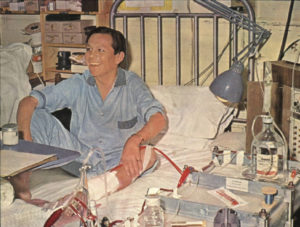 Man in hospital bed with machinery